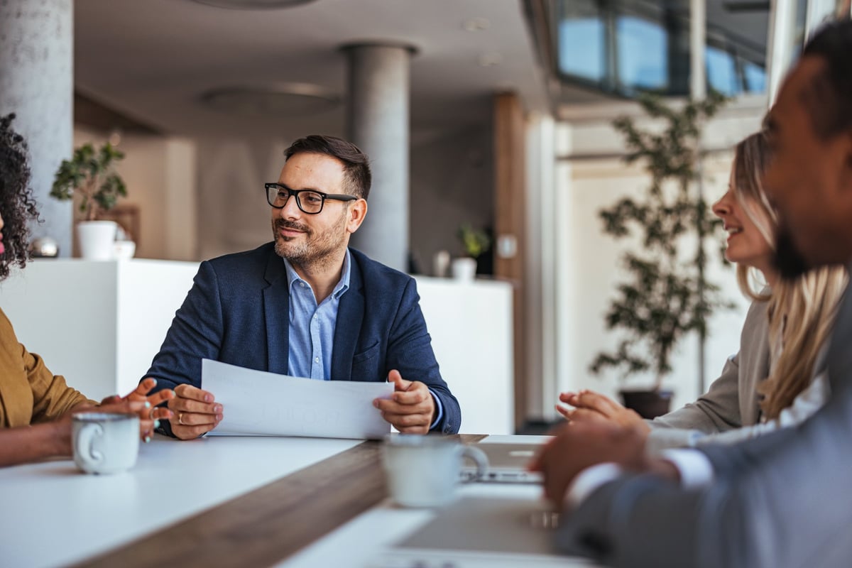 A diverse team engages in a productive business meeting in a modern office. The professional atmosphere is enhanced by teamwork and collaboration.